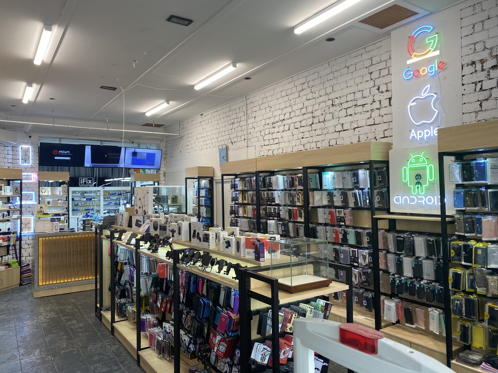 Wall of phone cases and accessories at iFix Brunswick